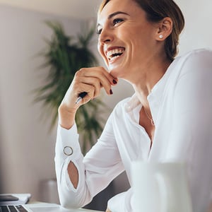 woman laughing in business meeting