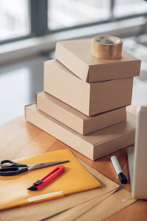 packages-stacked-round-wooden-office-desk