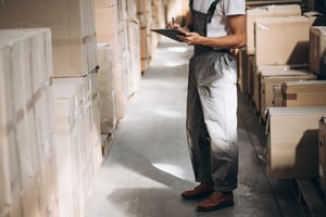 young-man-working-warehouse-with-boxes